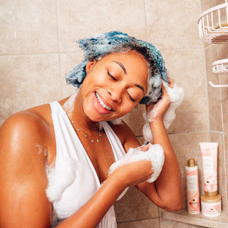 Black woman washing hair with Pantene Miracle Moisture Boost
