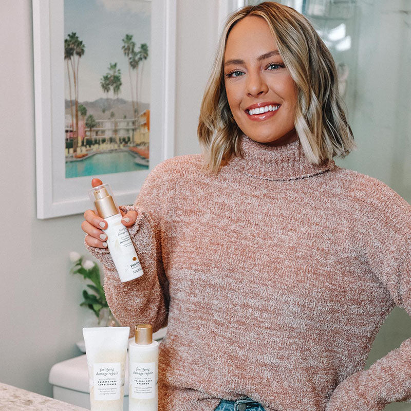 Woman displaying Pantene fortifying repair collection