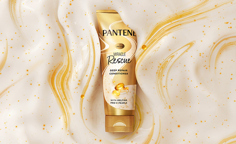Pantene pro-v melting pearls gold bottle sinking into deep repair conditioner with swirls