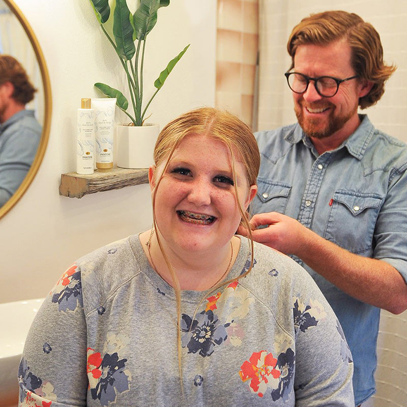 Dad braiding his child's hair