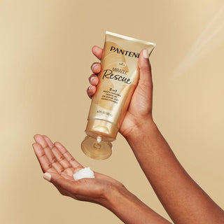 Miracle Rescue 3-in-1 Multi-Tasking Leave-in or Rinse Off Conditioner in hand