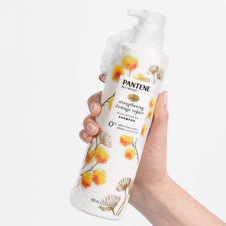 Strengthening Damage Repair Shampoo with Castor Oil in hand