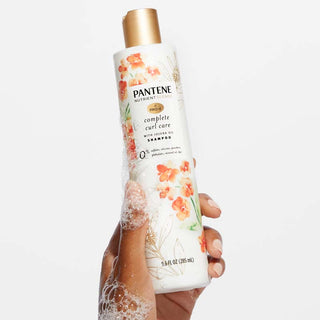 Complete Curl Care Shampoo with Jojoba Oil in hand